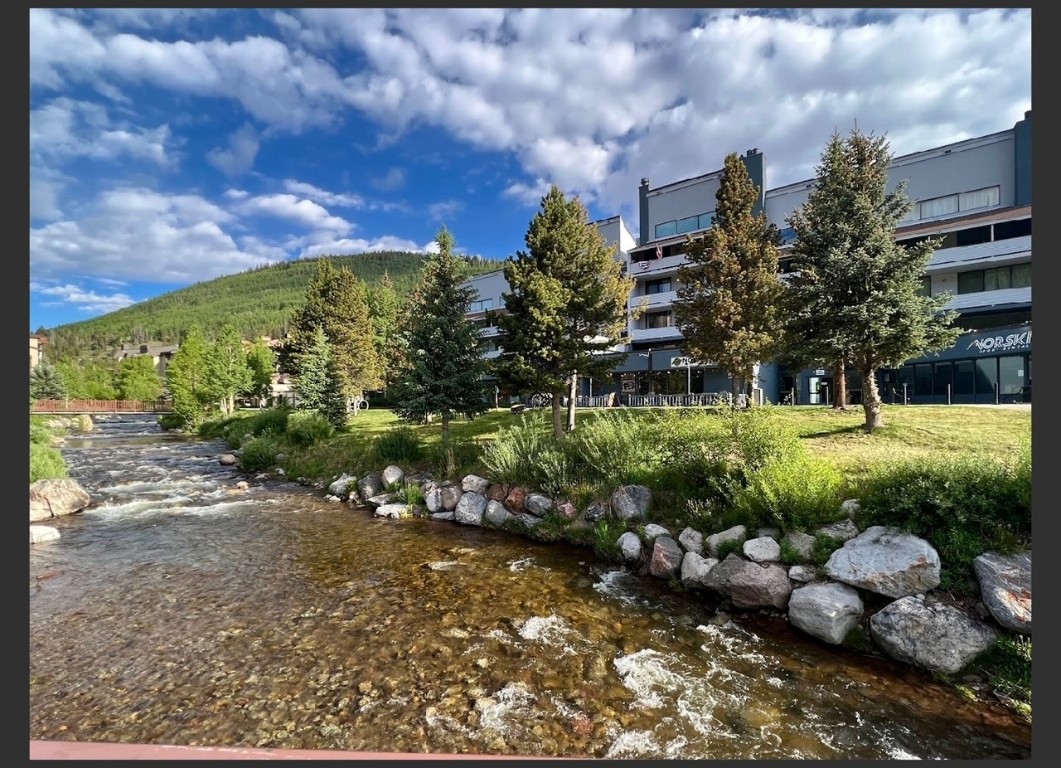 760 Copper Road, Unit E111 Copper Mountain, CO 80443 - Photo 1 of 14 a view of a garden with a building in the background