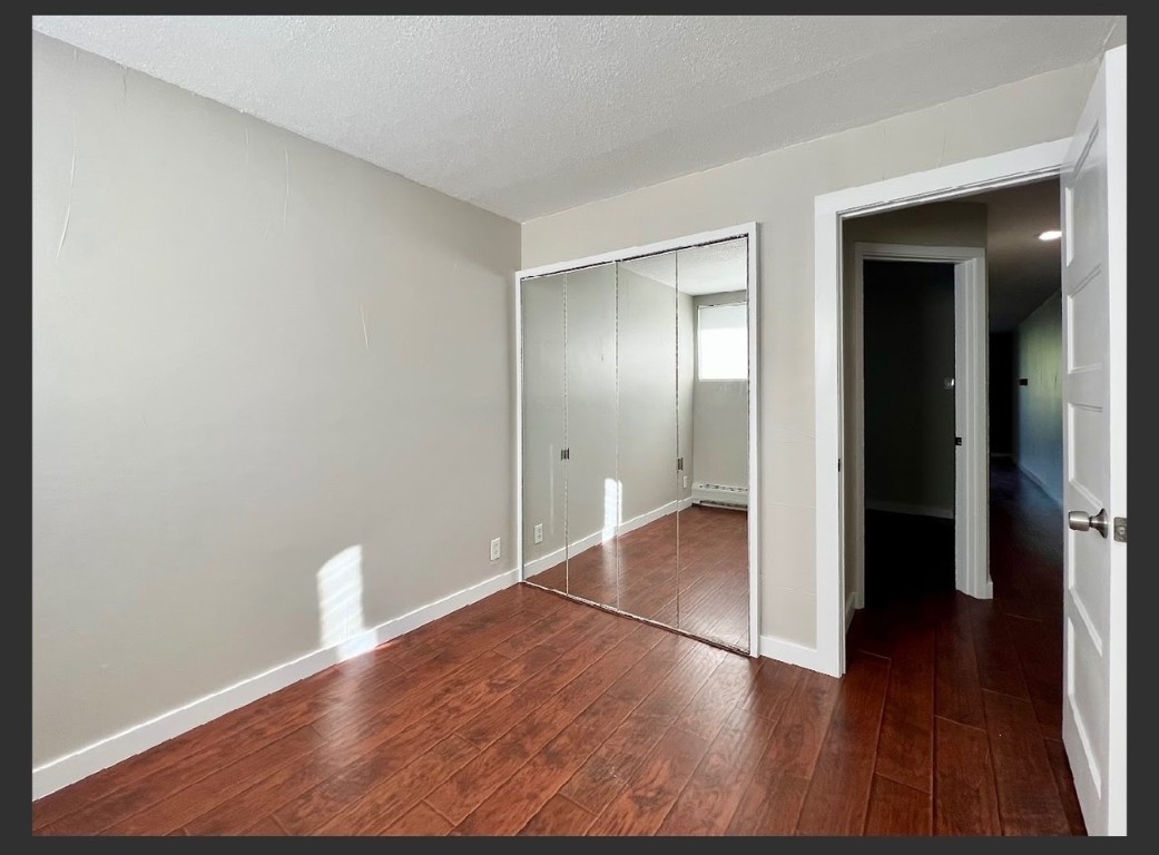760 Copper Road, Unit E111 Copper Mountain, CO 80443 - Photo 11 of 14 a view of an empty room with wooden floor