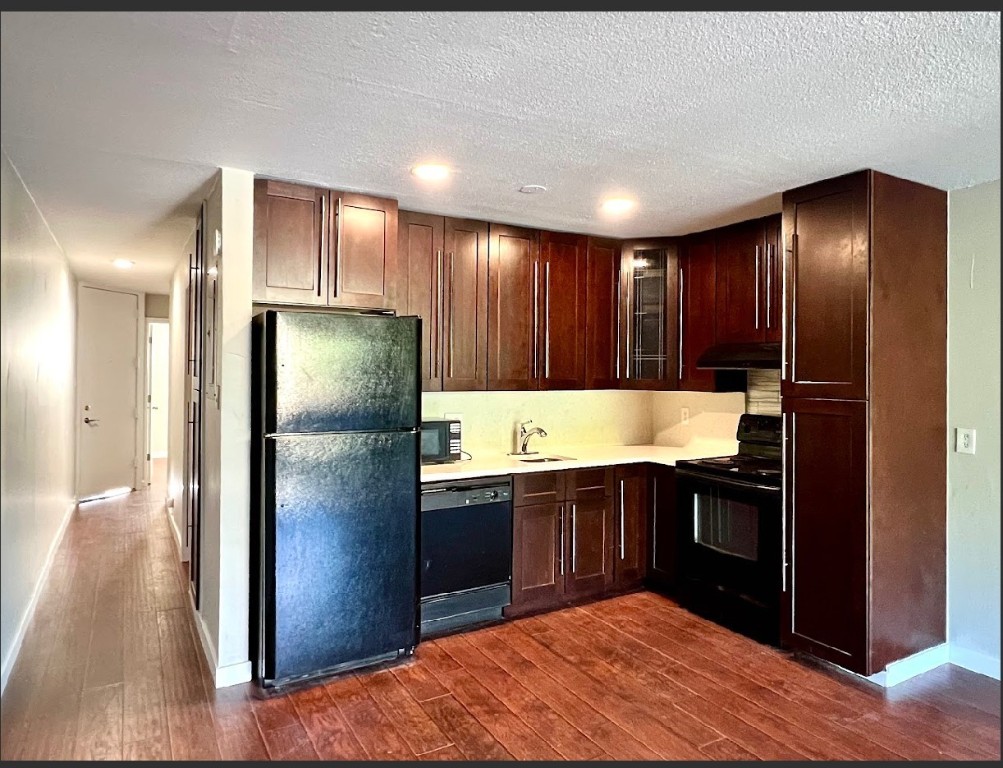 760 Copper Road, Unit E111 Copper Mountain, CO 80443 - Photo 2 of 14 a kitchen with stainless steel appliances granite countertop a refrigerator a sink and wooden cabinets