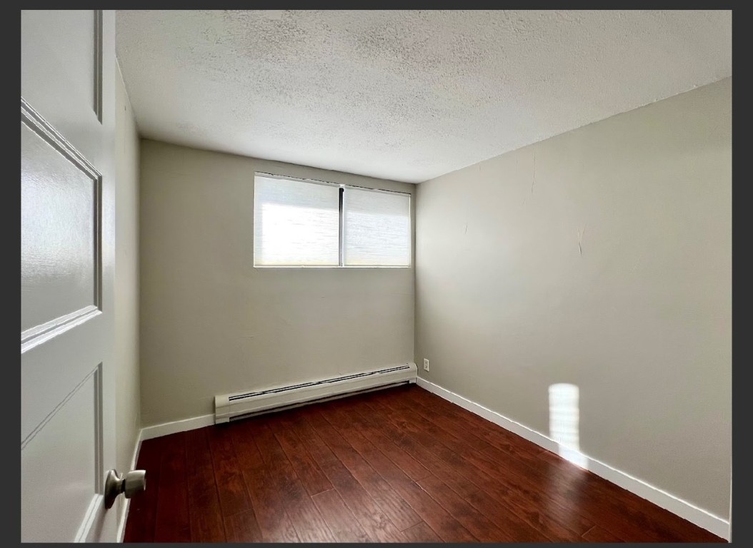 760 Copper Road, Unit E111 Copper Mountain, CO 80443 - Photo 10 of 14 an empty room with wooden floor and window