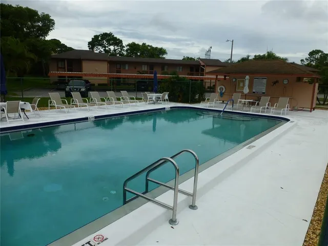 a view of swimming pool with outdoor seating yard and barbeque oven