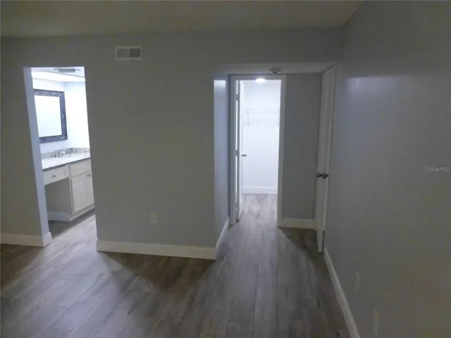 a view of a hallway with wooden floor