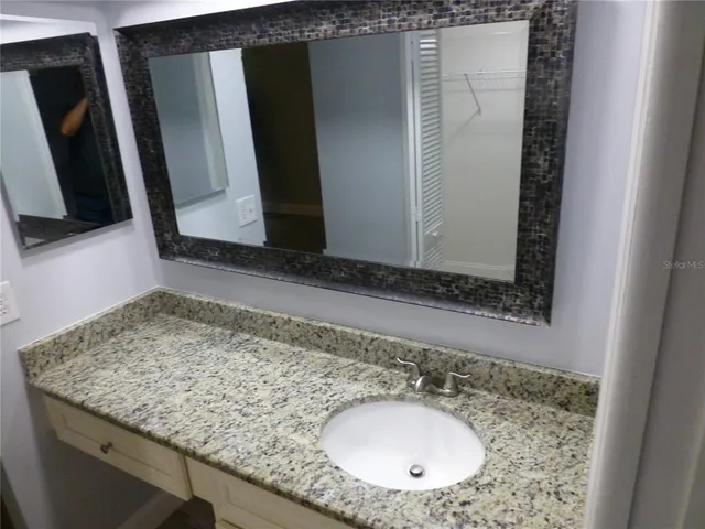 a bathroom with a sink and a mirror