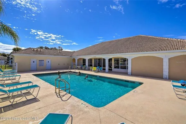 a aerial view of a house with swimming pool and a yard
