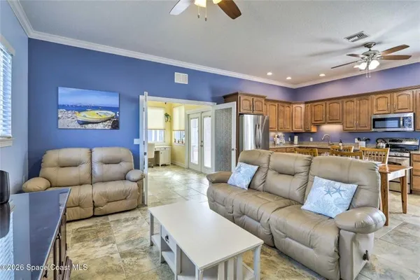 a living room with furniture and a chandelier