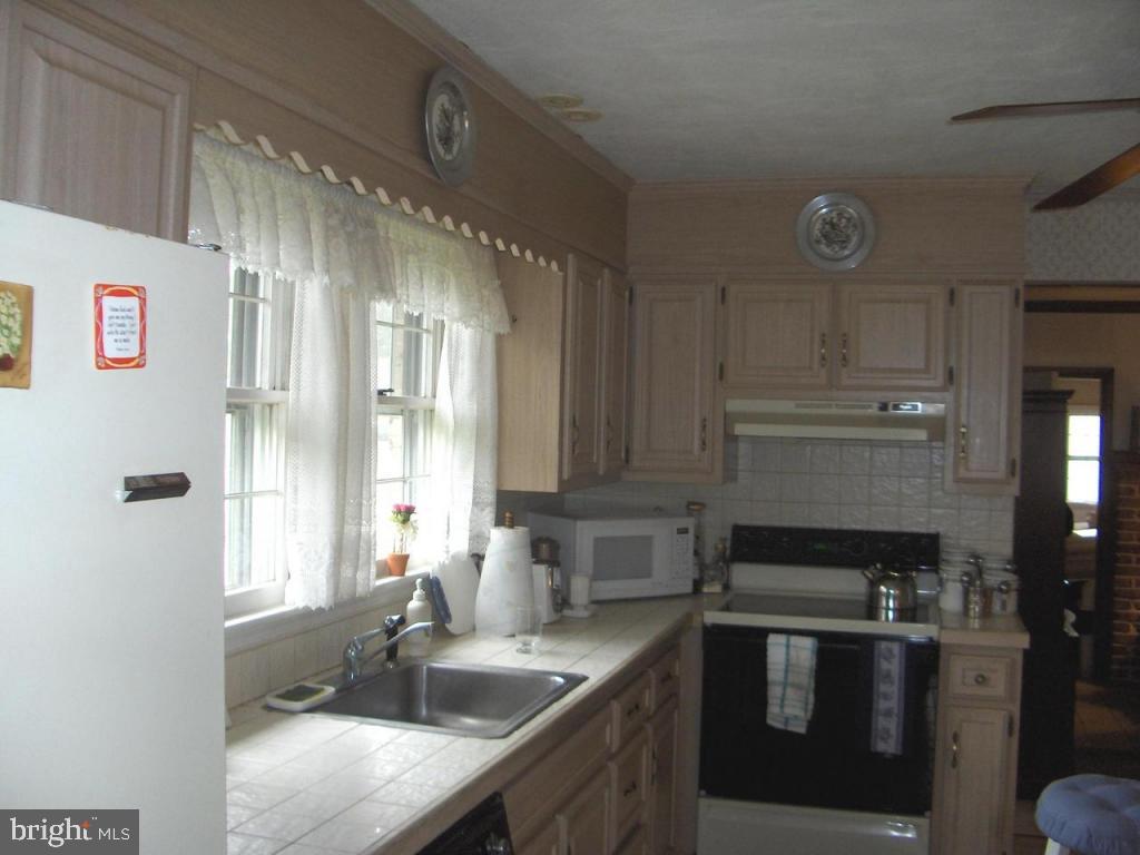 217 St Thomas Road Lancaster, PA 17601 - Photo 3 of 10 a kitchen with a sink and a refrigerator
