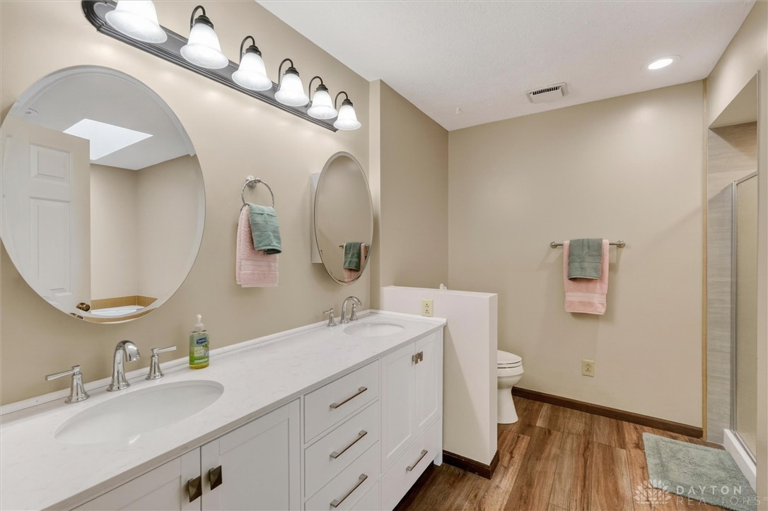 2165 Stewart Road Xenia, OH 45385 - Photo 35 of 59 This bathroom features a double vanity and recessed lighting, creating a bright and inviting atmosphere.