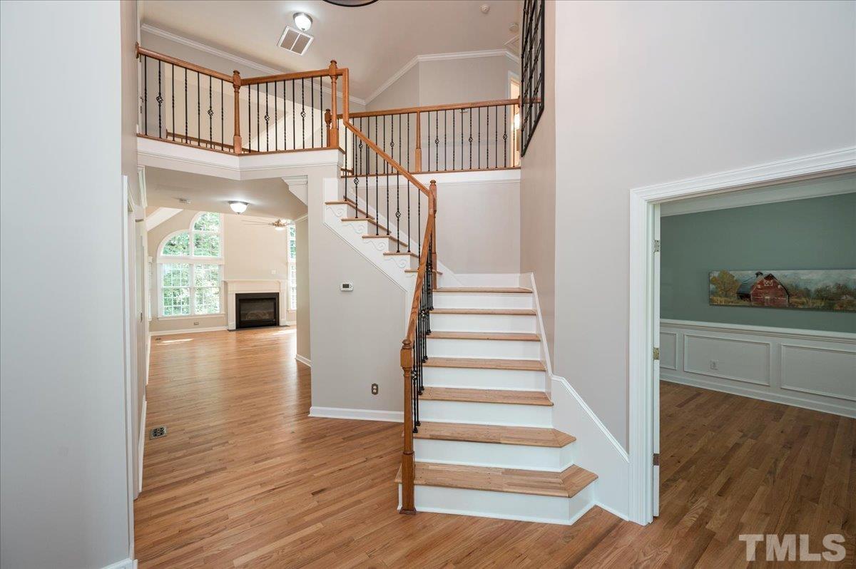5017 Perception Lane Raleigh, NC 27613 - Photo 16 of 47 a view of staircase with white walls and wooden floor