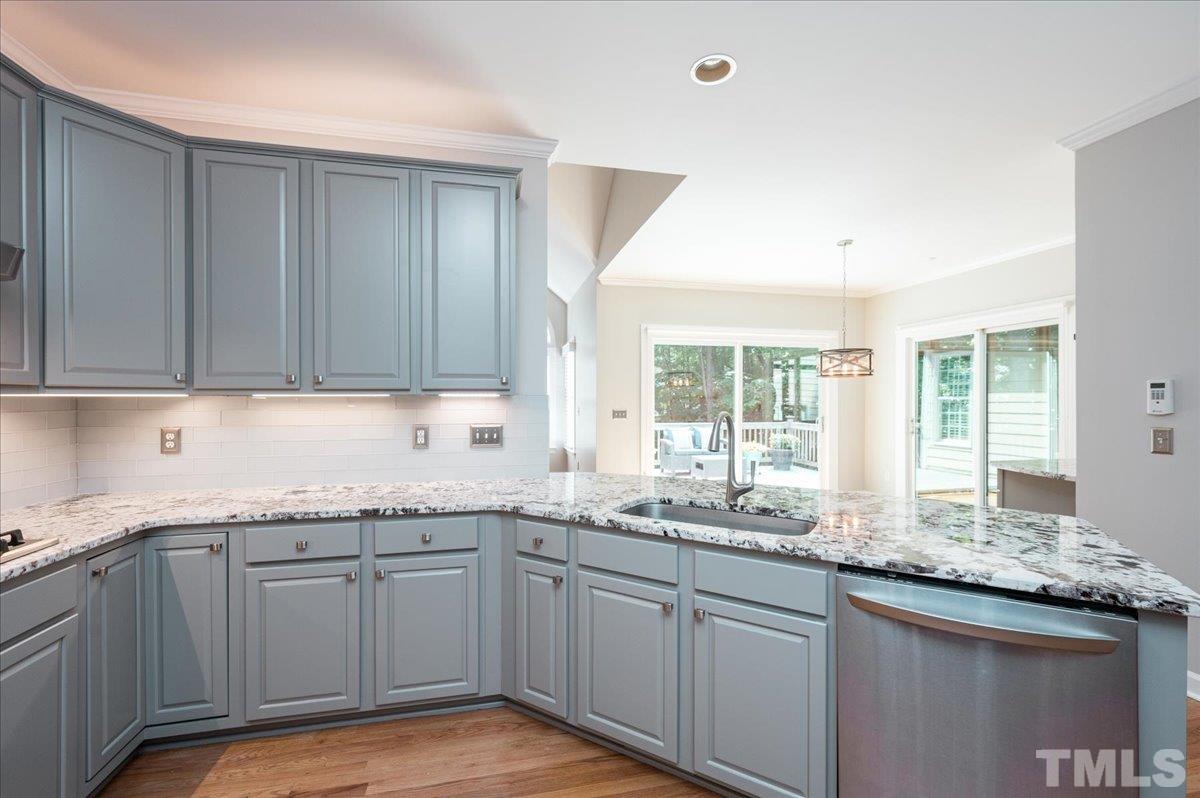 5017 Perception Lane Raleigh, NC 27613 - Photo 21 of 47 a kitchen with granite countertop stainless steel appliances white cabinets and a window