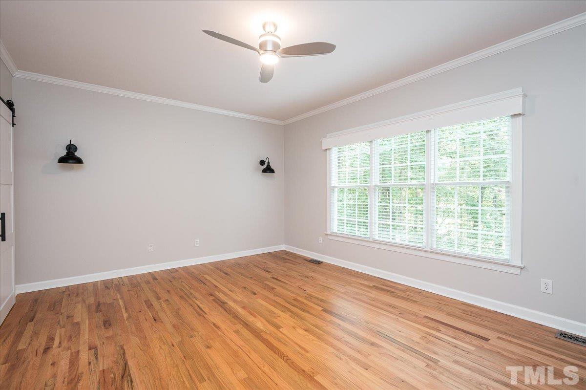 5017 Perception Lane Raleigh, NC 27613 - Photo 31 of 47 a view of an empty room with a window and wooden floor