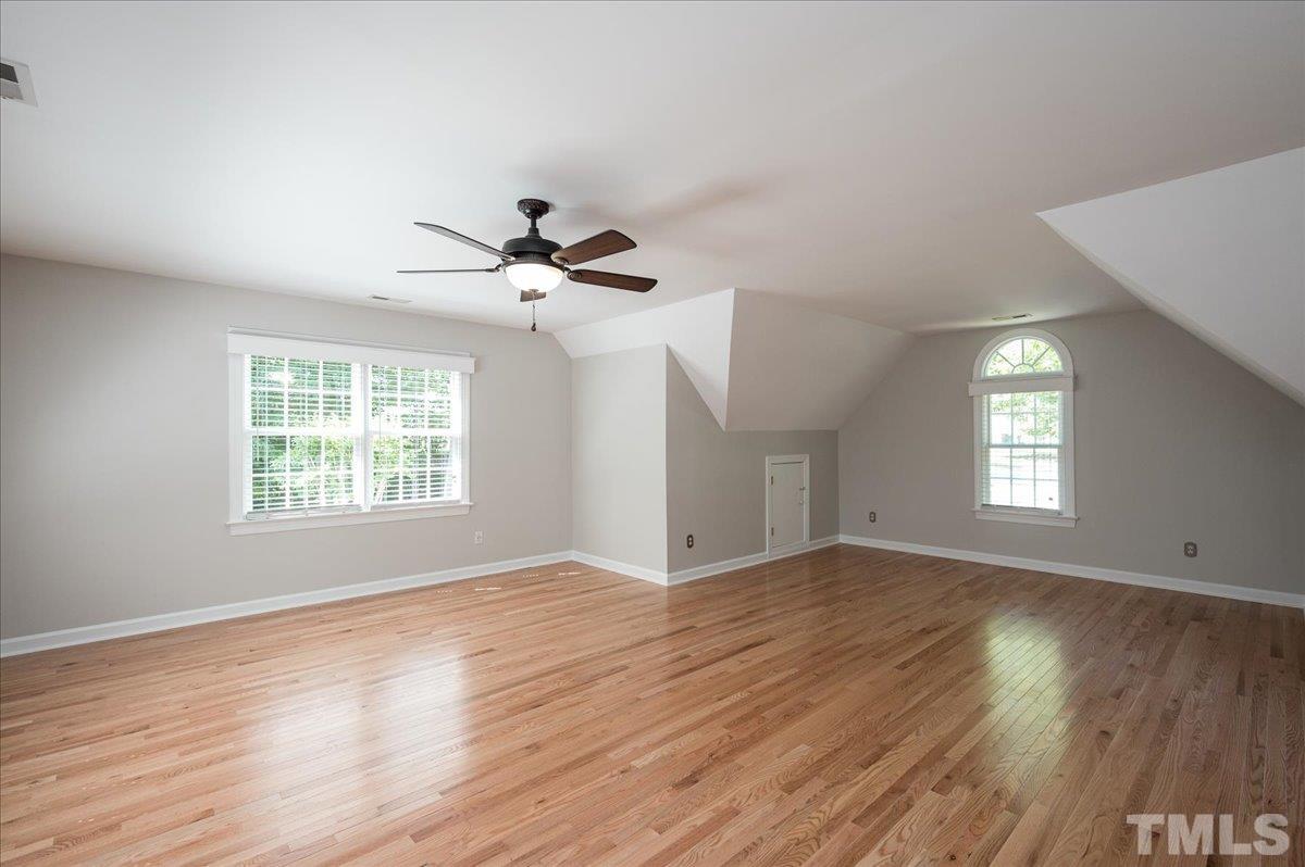 5017 Perception Lane Raleigh, NC 27613 - Photo 37 of 47 a view of an empty room with wooden floor and a window