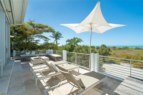 a view of a balcony with floor to ceiling windows