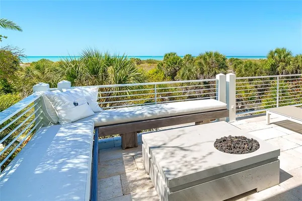 a view of a balcony with floor to ceiling windows and wooden floor