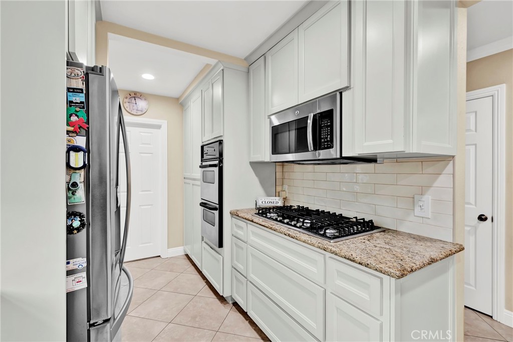 2501 Deodar Street Santa Ana, CA 92705 - Photo 11 of 43 a kitchen with stainless steel appliances granite countertop a stove and a refrigerator