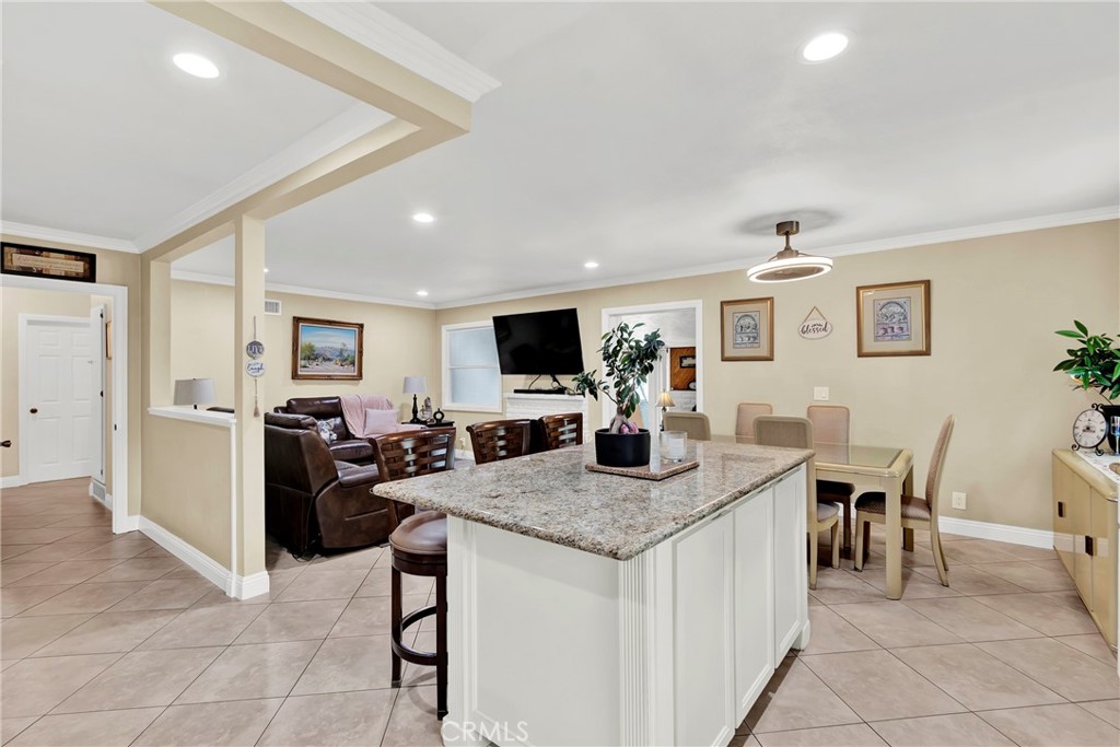 2501 Deodar Street Santa Ana, CA 92705 - Photo 12 of 43 a view of kitchen island with granite countertop couches chair and fireplace