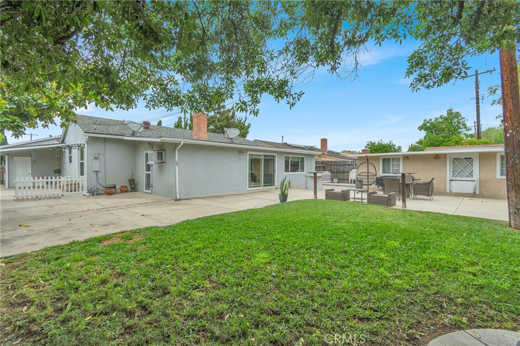 2501 Deodar Street Santa Ana, CA 92705 - Photo 29 of 43 a backyard of a house with table and chairs plants and large tree