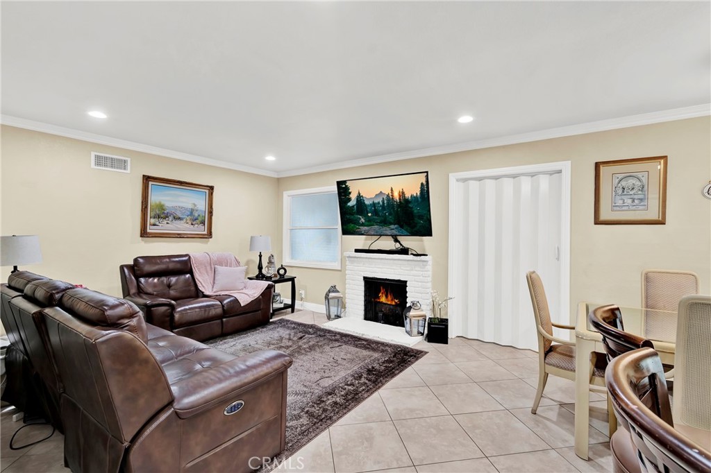 2501 Deodar Street Santa Ana, CA 92705 - Photo 7 of 43 a living room with furniture a flat screen tv and a fireplace