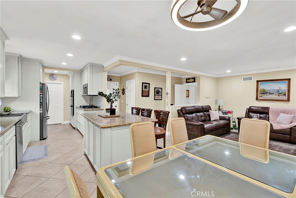 2501 Deodar Street Santa Ana, CA 92705 - Photo 8 of 43 a living room with stainless steel appliances furniture a rug kitchen view and a chandelier