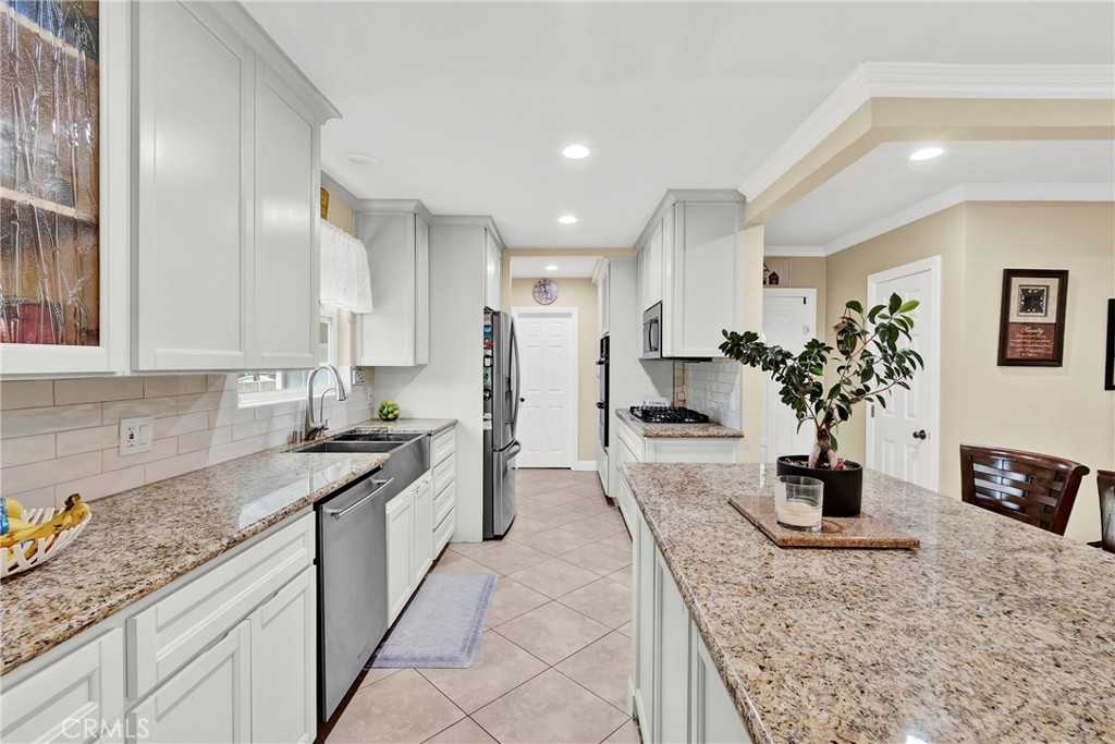 2501 Deodar Street Santa Ana, CA 92705 - Photo 9 of 43 a kitchen with stainless steel appliances granite countertop a sink stove and refrigerator