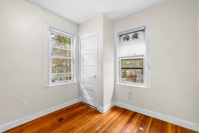 wooden floor in an empty room with a window