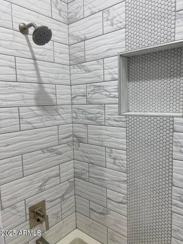 a view of a hallway with wooden floor and chandelier