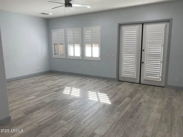 a view of a kitchen counter space a sink wooden floor and a window
