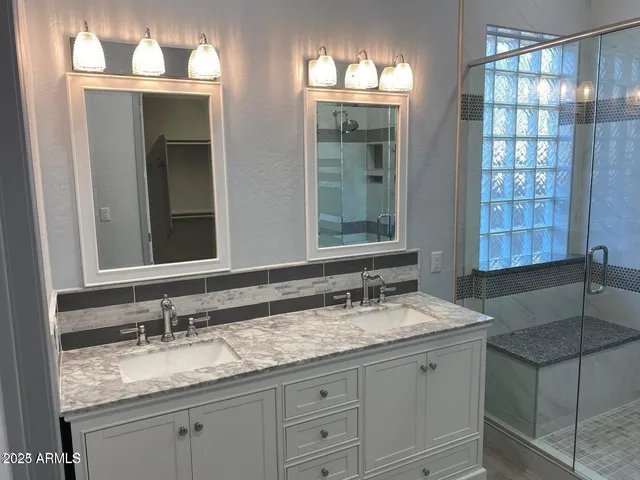 a bathroom with a sink and a mirror