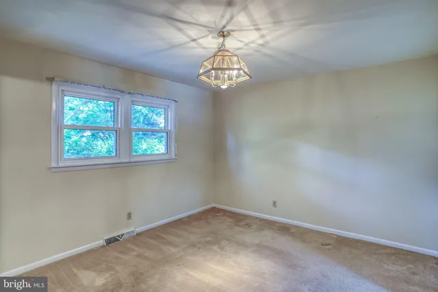 a large kitchen with stainless steel appliances granite countertop a refrigerator and a sink