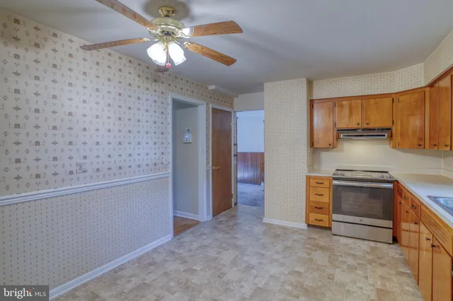 a kitchen with granite countertop a sink stainless steel appliances and cabinets