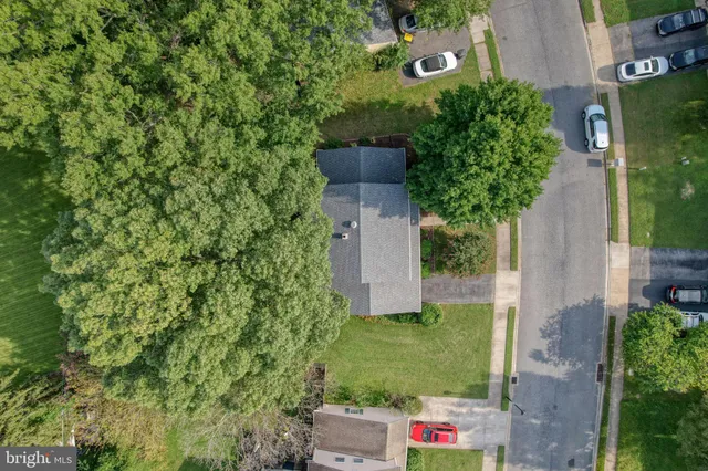 an aerial view of a house with a yard basket ball court and outdoor seating
