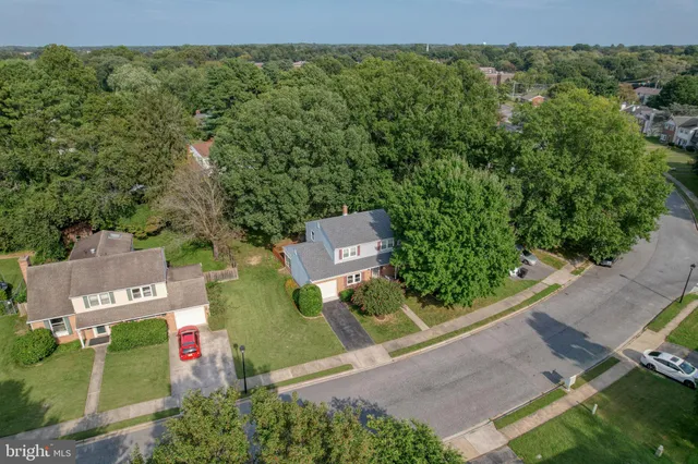 an aerial view of a house with garden space and street view