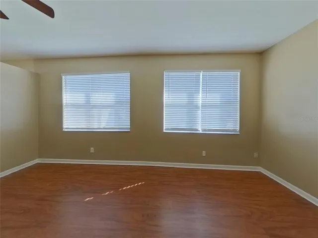 a view of a room with wooden floor and a window