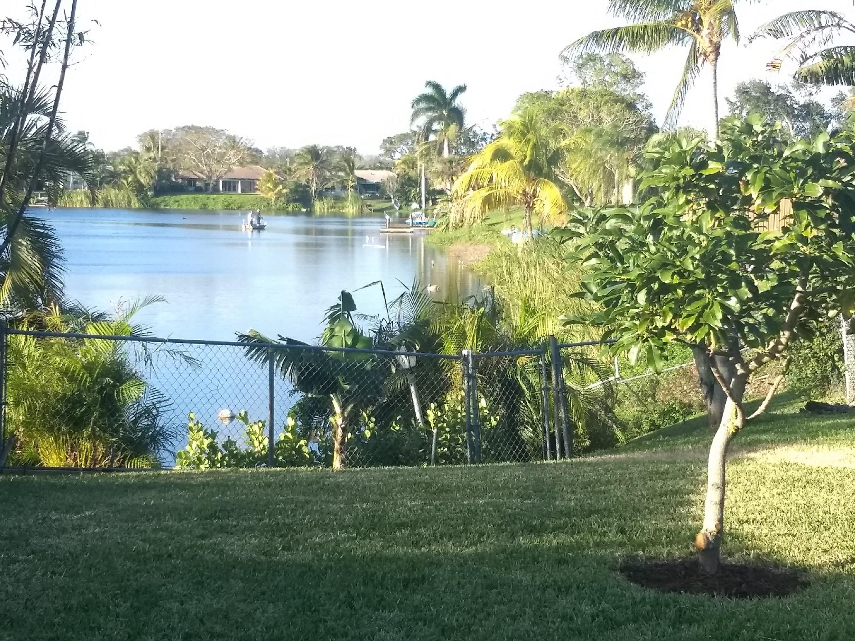 1031 Southwest 11th Street Boca Raton, FL 33486 - Photo 4 of 28 a view of a lake with houses in the back