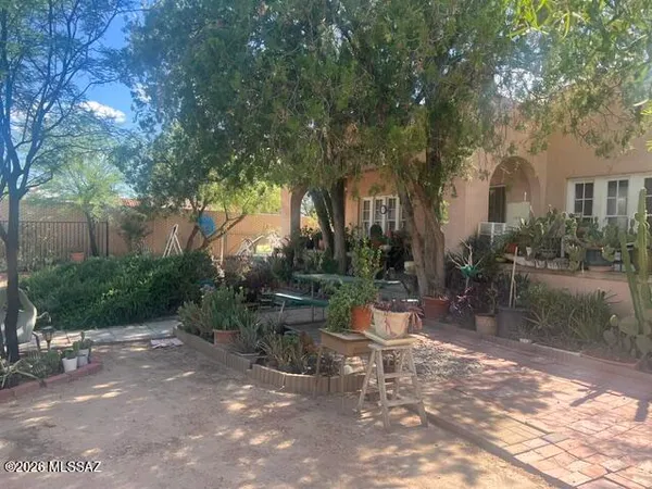 a view of a patio with table and chairs and potted plants