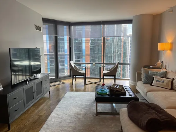 a living room with furniture tv and a large window