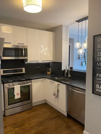 a kitchen with stainless steel appliances a stove a sink and a microwave