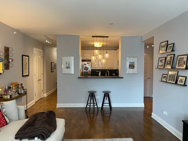 a living room with furniture and a book shelf
