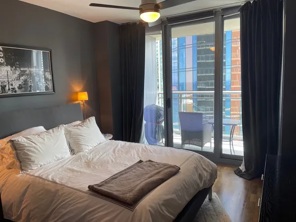a bedroom with a bed and a lamp next to a window