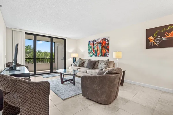 a living room with furniture and a floor to ceiling window