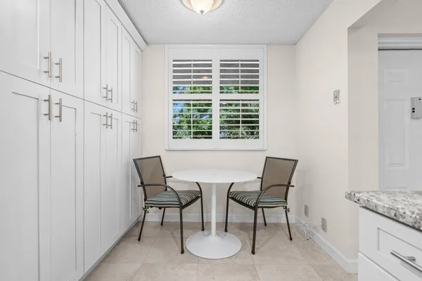 a kitchen with stainless steel appliances granite countertop a refrigerator a stove and a sink