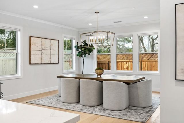 a dining room with table chairs and chandelier