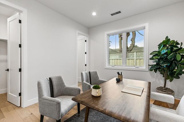 a dining room with furniture and a window