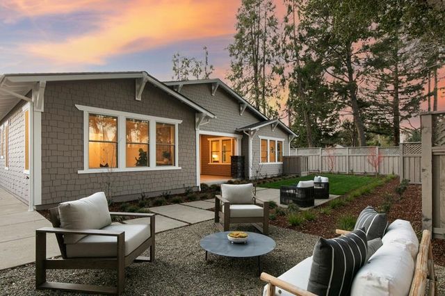 a backyard of a house with table and chairs