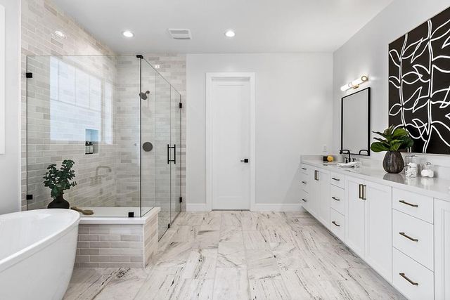 a white bath tub sitting next to a white sink