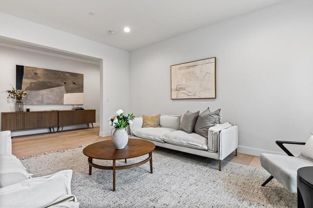 a living room with furniture a window and appliances