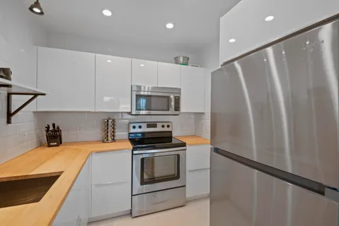 a kitchen with stainless steel appliances a refrigerator stove and microwave