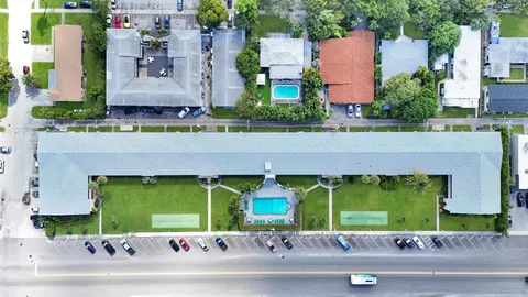 an aerial view of a house with a yard and potted plants
