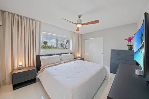 a bedroom with a bed dresser and a window