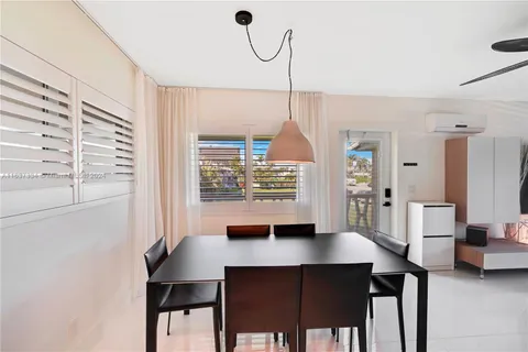 a view of a dining room with furniture and window