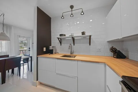 a kitchen with kitchen island a sink stainless steel appliances and cabinets